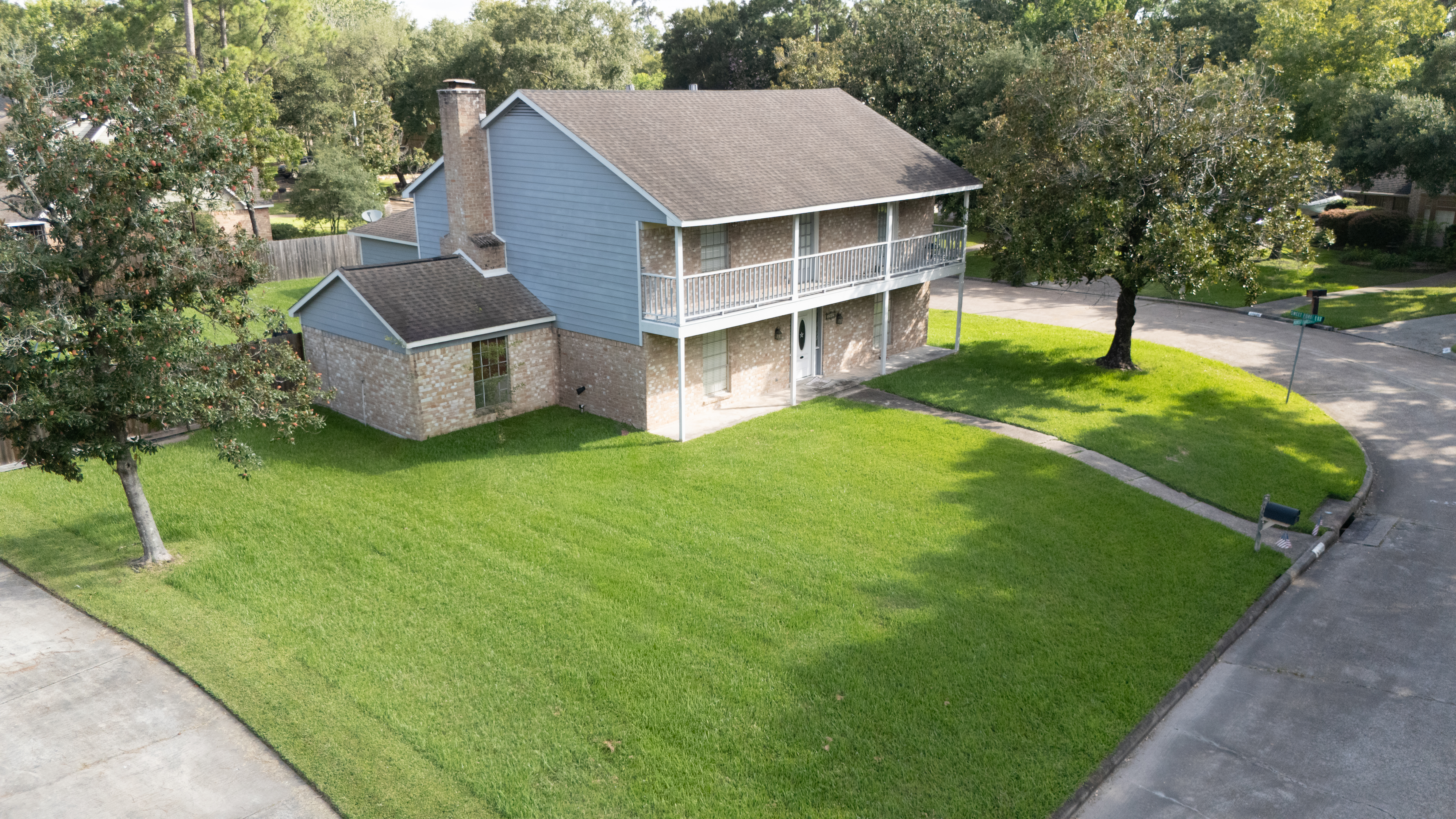 Aerial front view of a two-story home on a corner lot