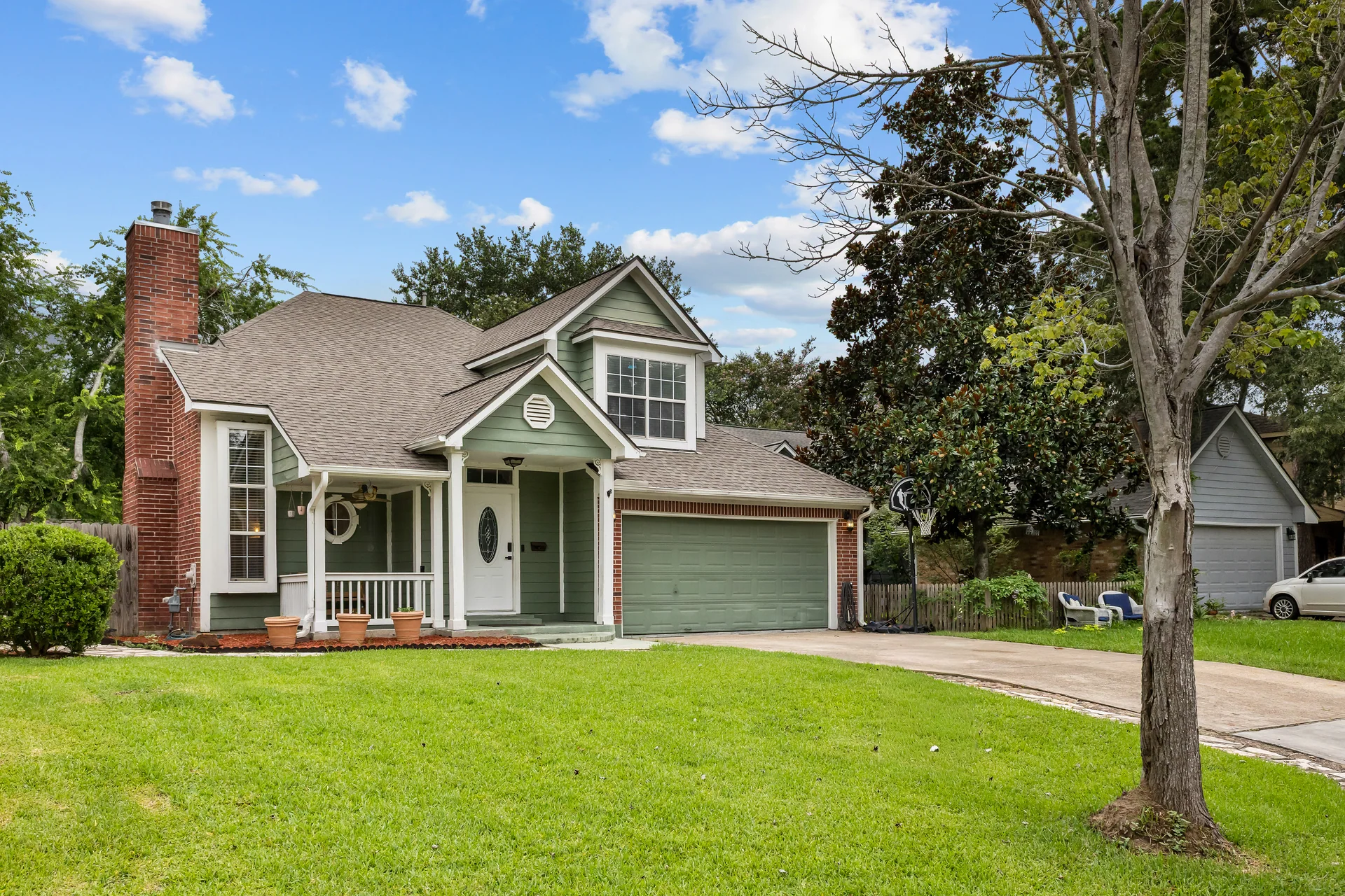 Angled front exterior of a green suburban home