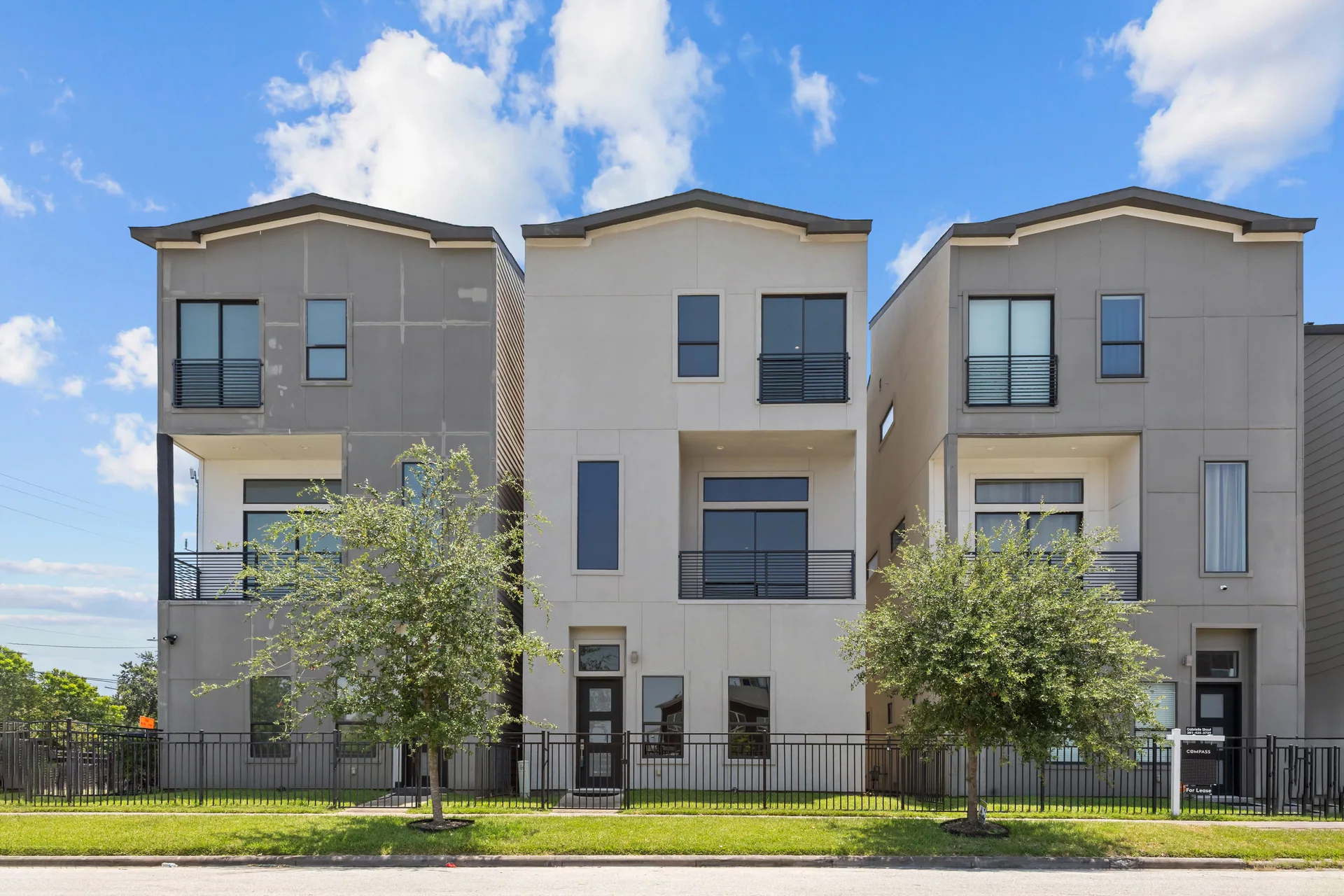 Front elevation of three modern townhomes