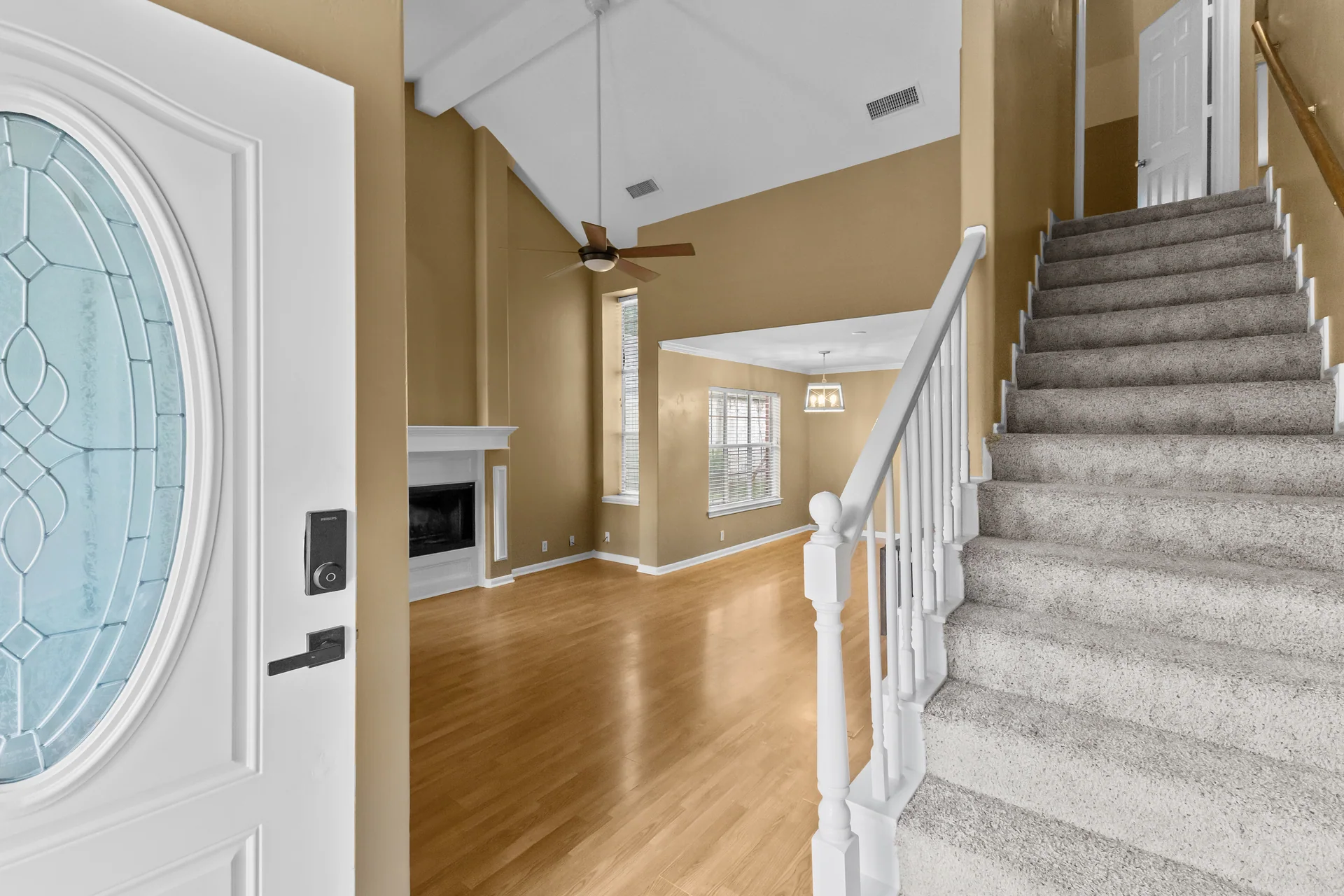 Entry hall opening into a naturally lit living area