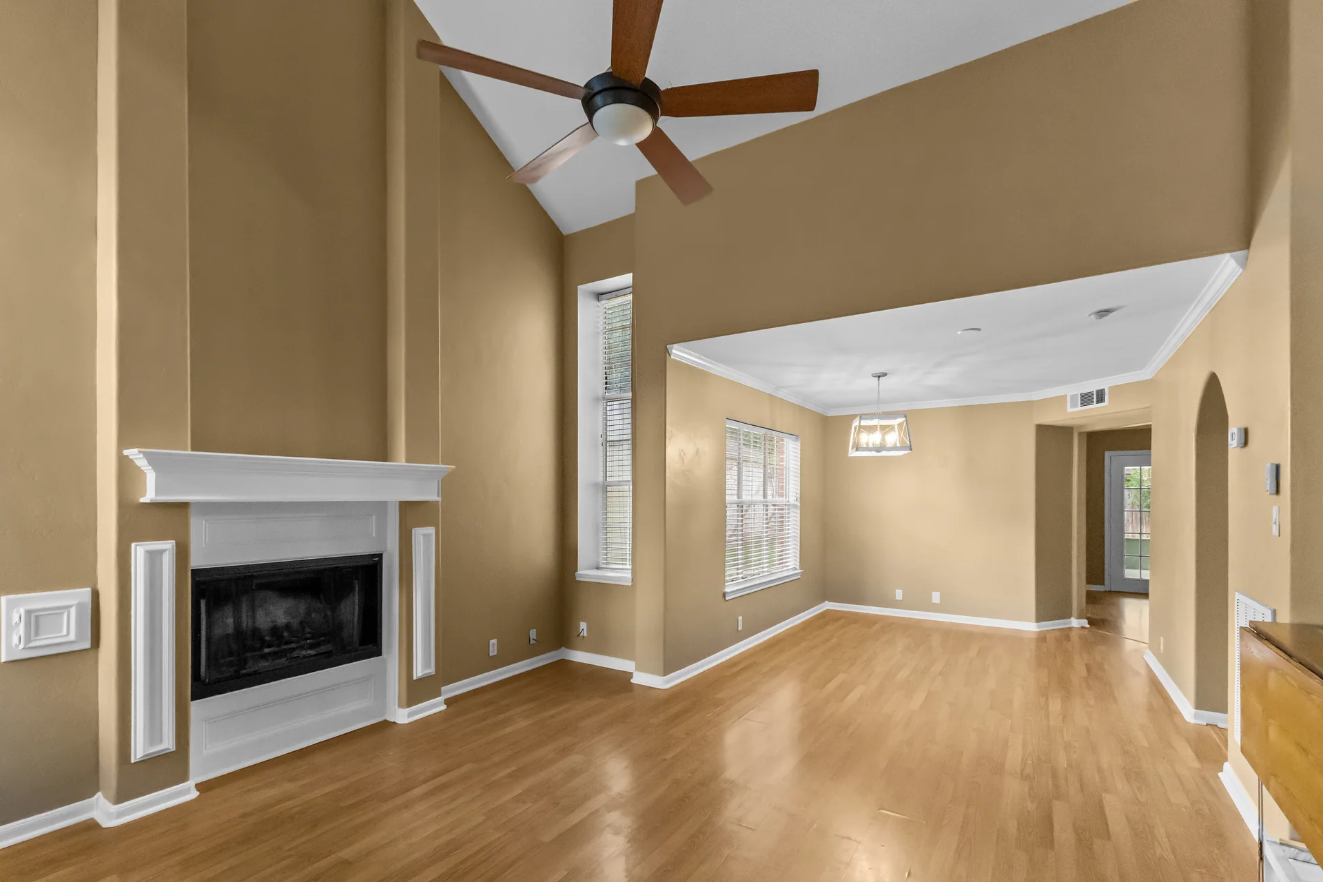 Living and dining room with fireplace and wood floors