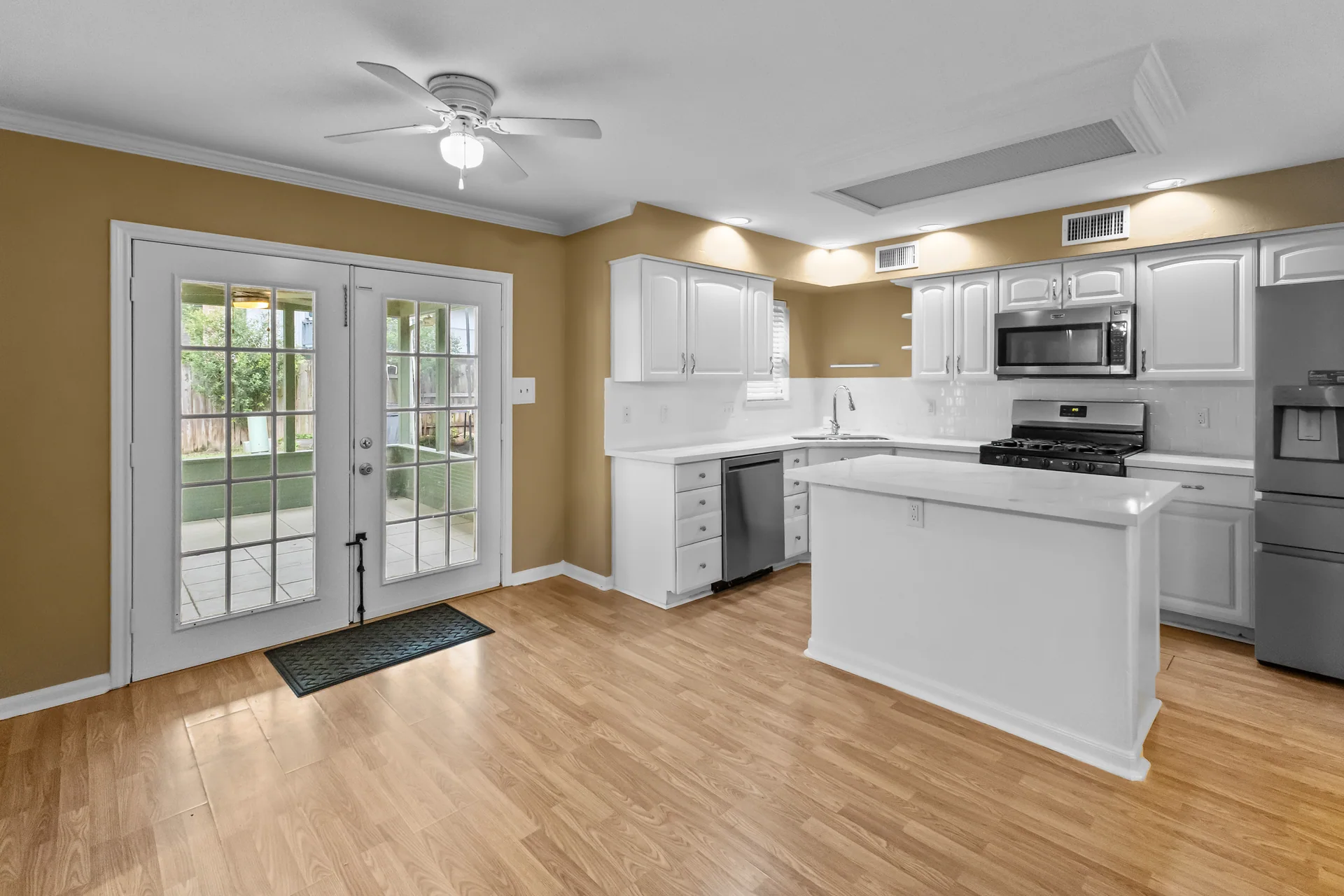 White kitchen with island and French doors