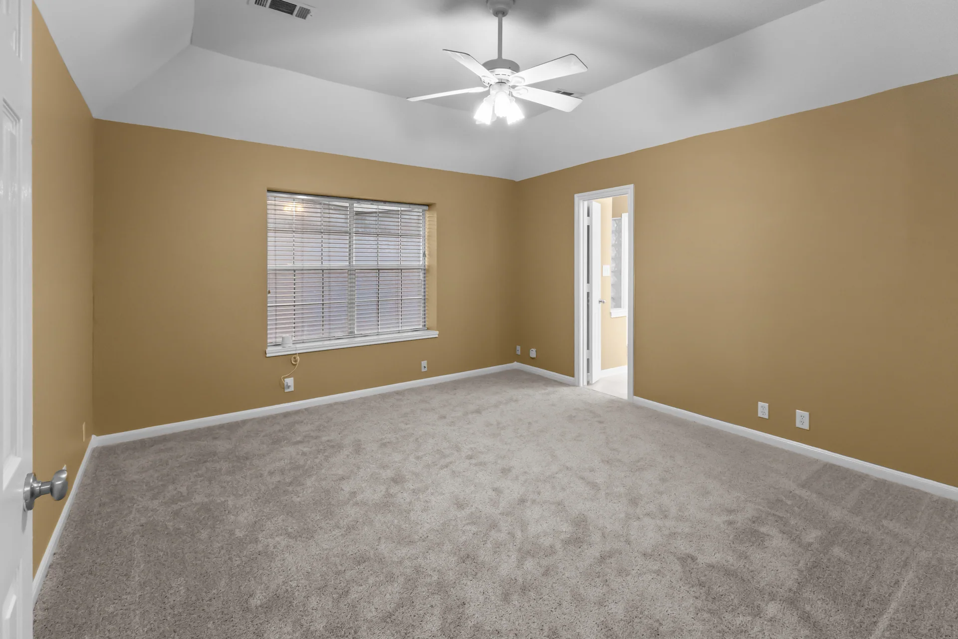Clean empty bedroom with neutral carpet