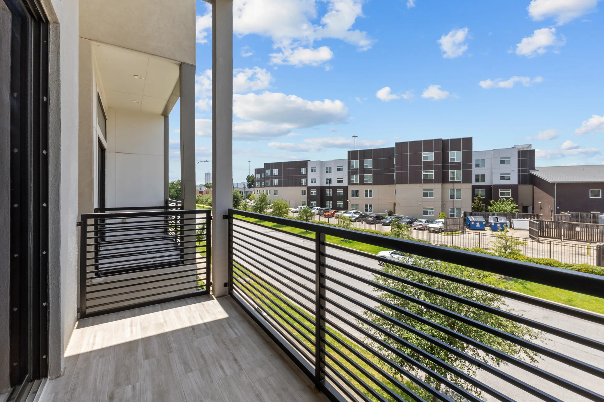 Private balcony overlooking a residential neighborhood
