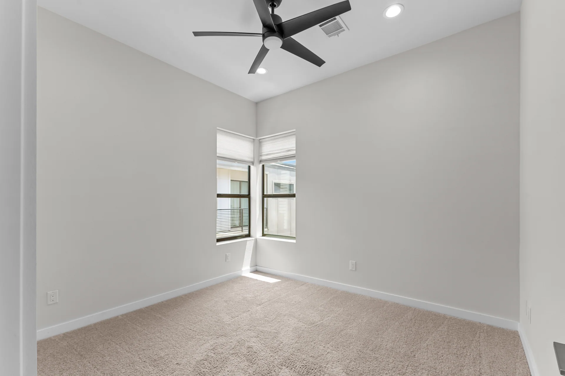 Empty bedroom with corner windows