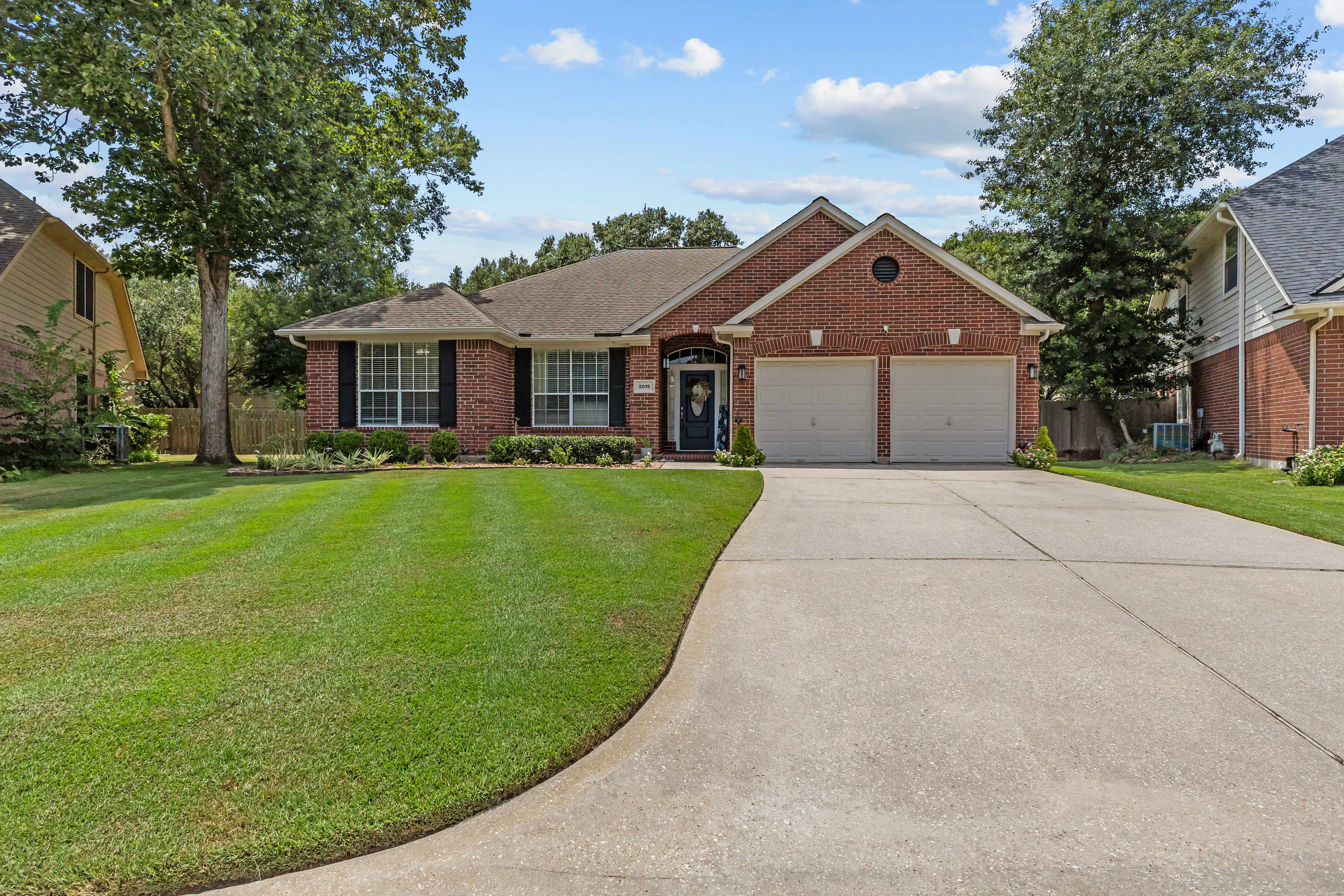 Front elevation of a well-kept brick suburban home