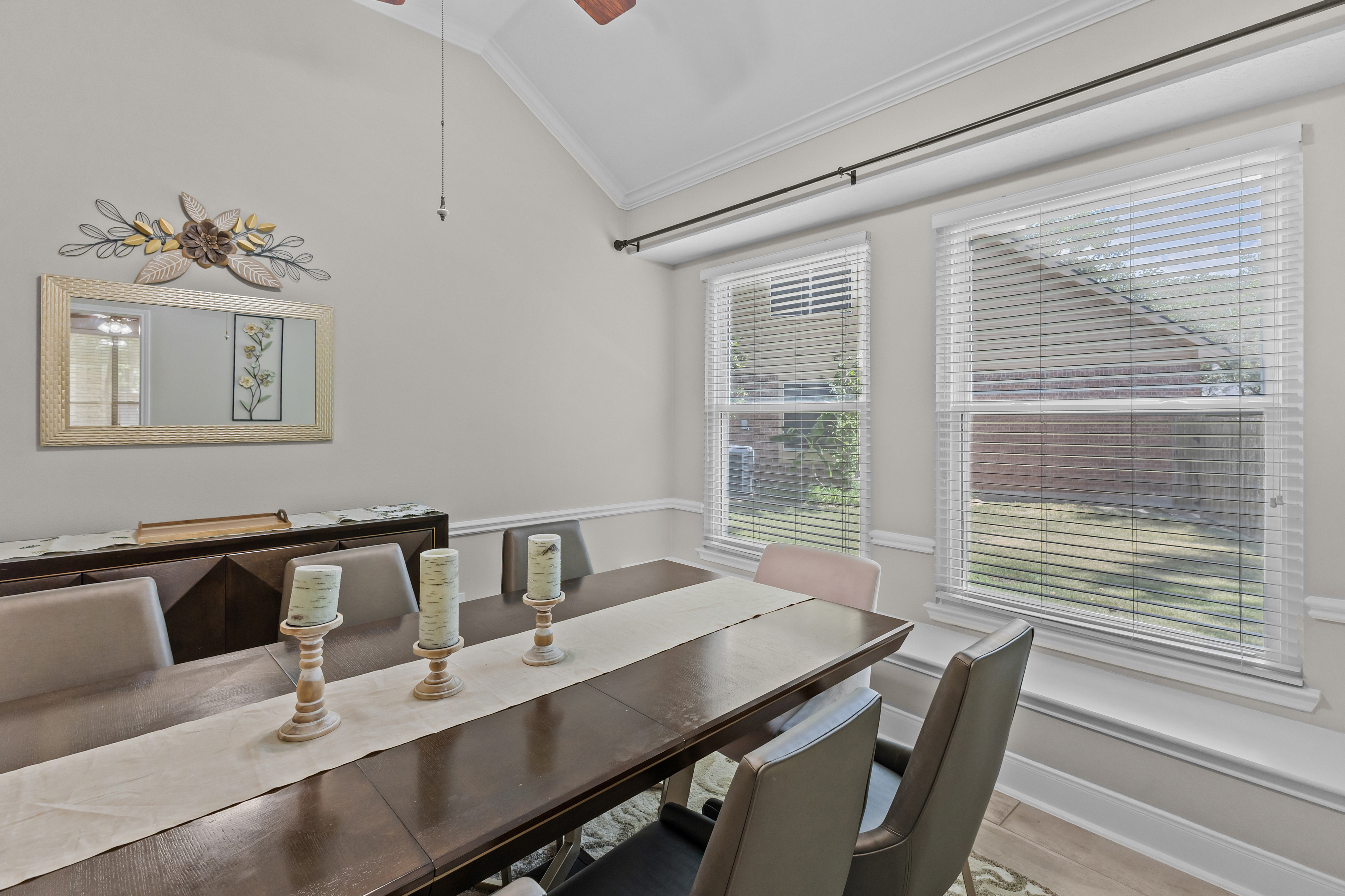 Dining table beside two tall windows
