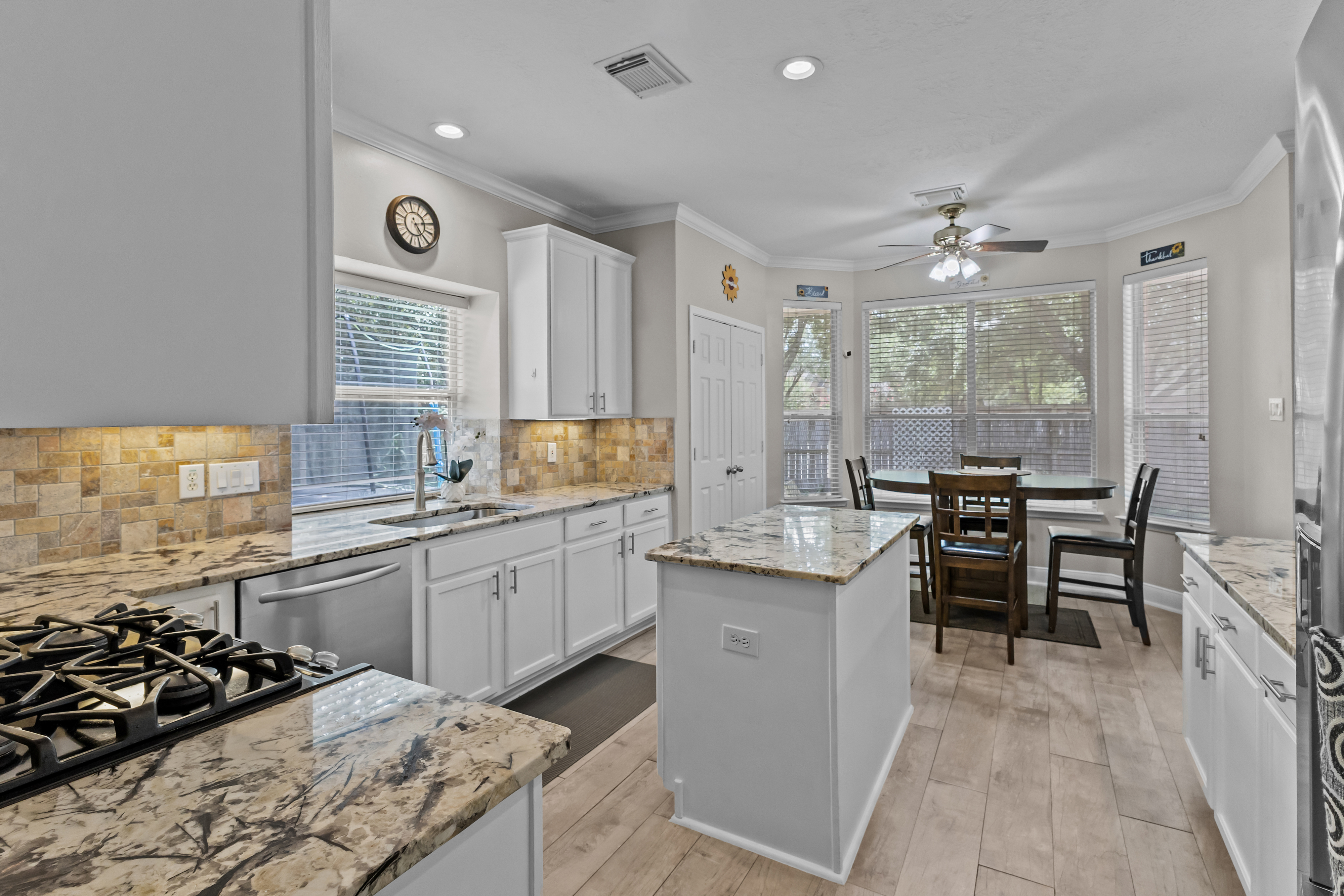 Updated white kitchen with island and breakfast area