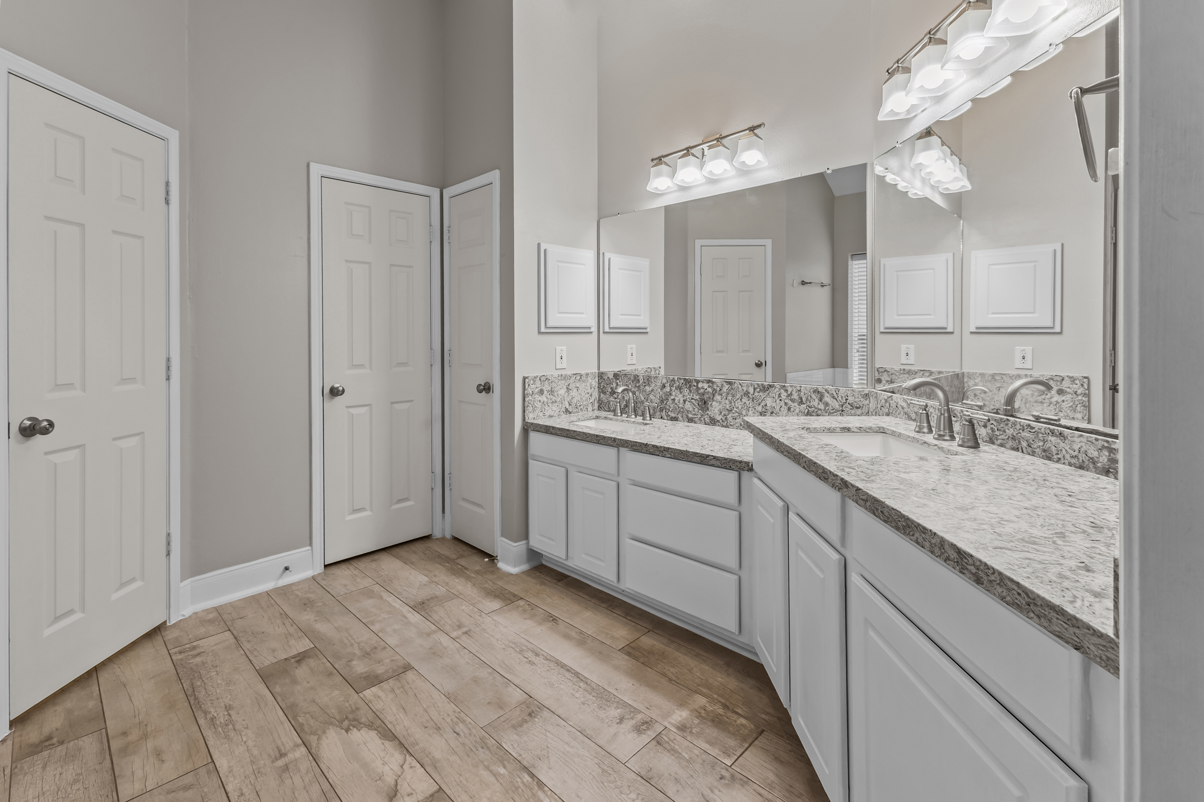 Double vanity in a bright primary bathroom