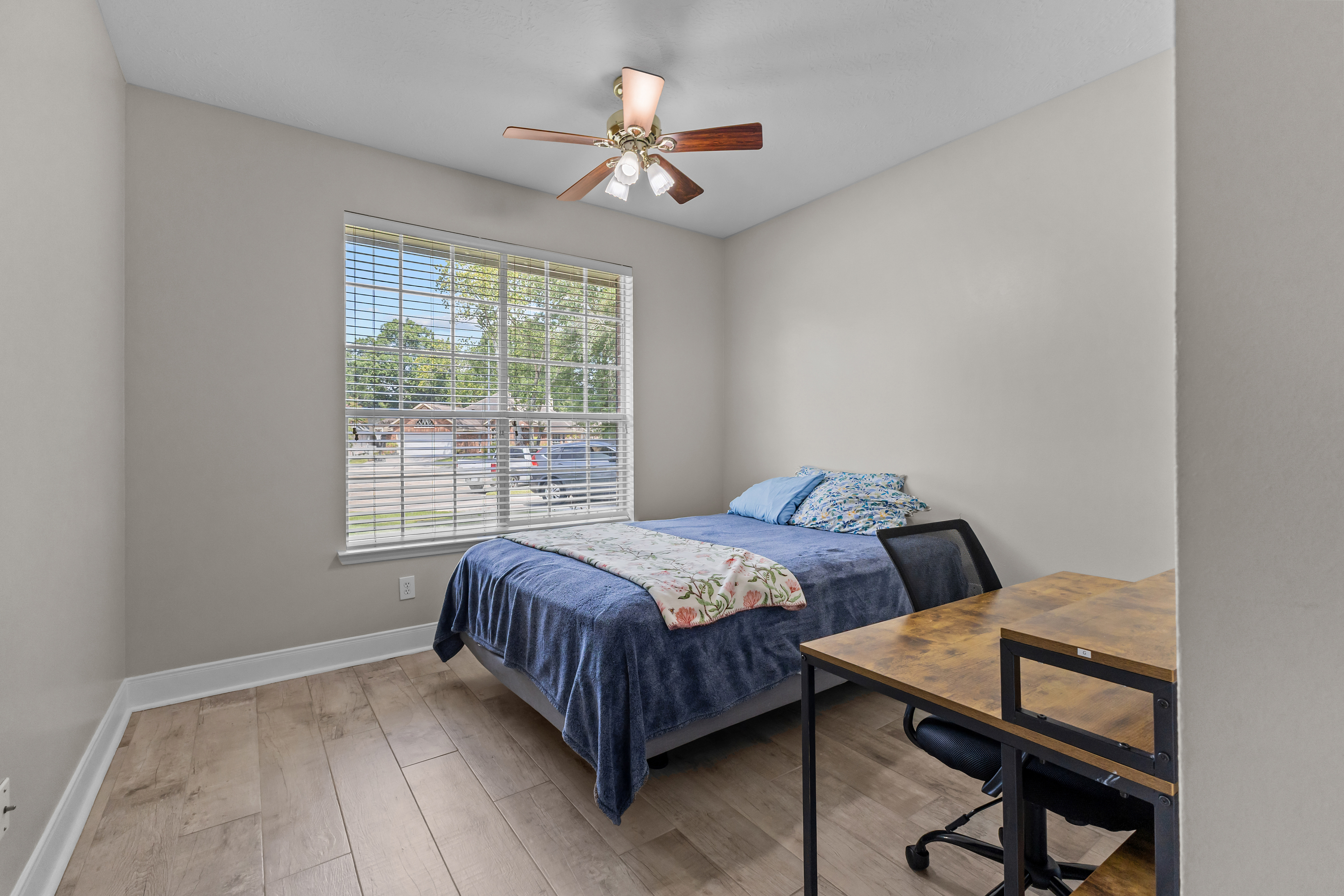 Bedroom with workspace and large front-facing window