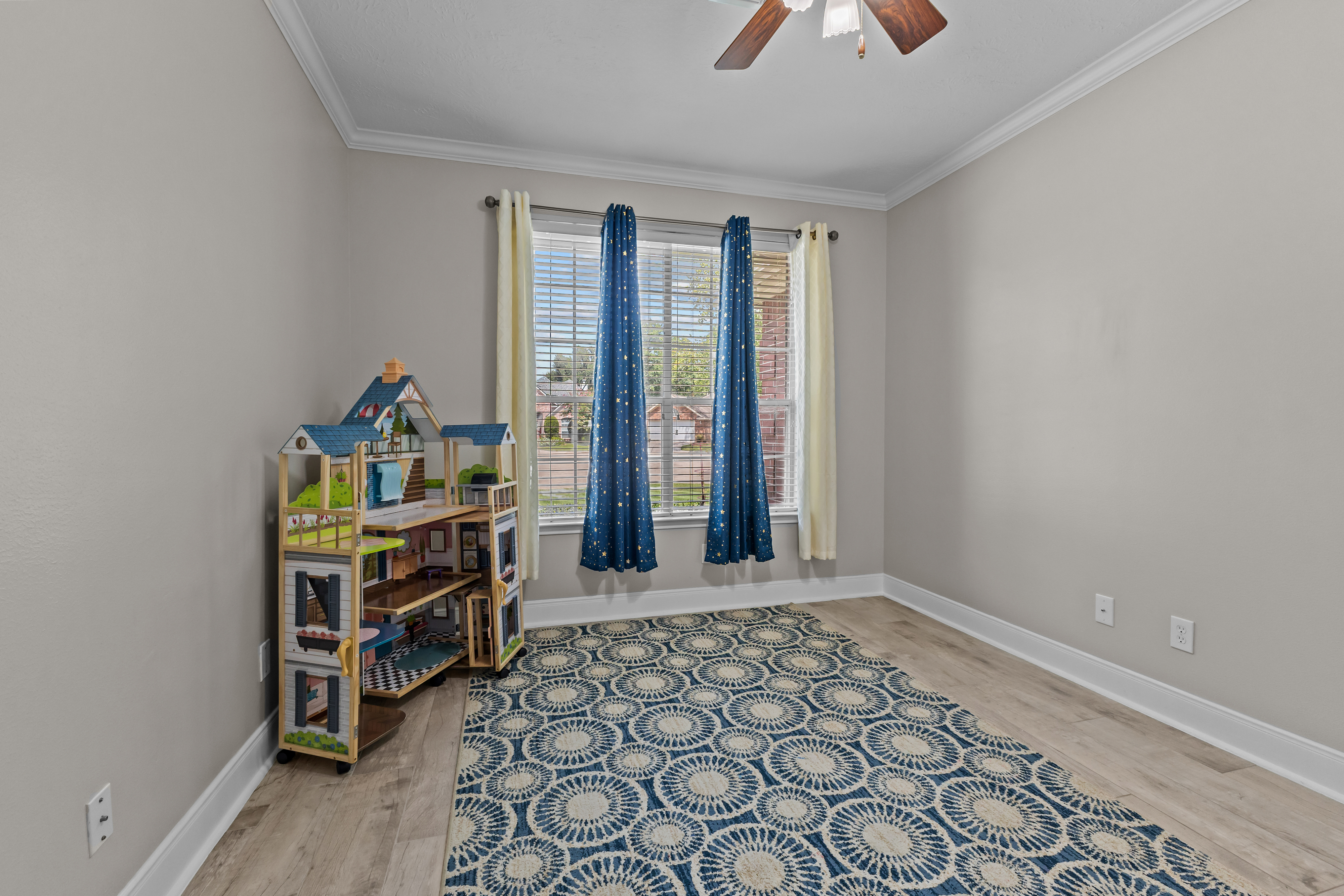 Children's room with patterned rug and dollhouse