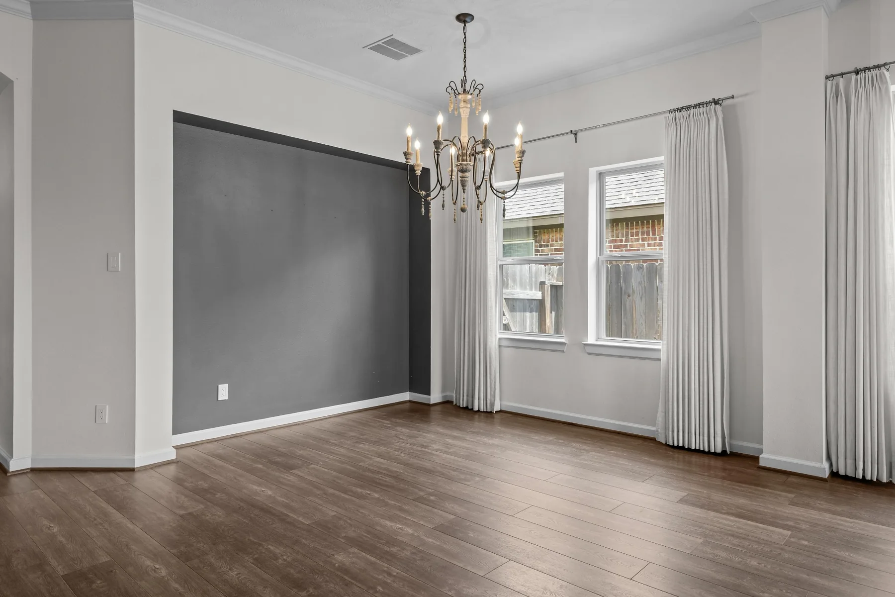 Dining area with chandelier and large windows