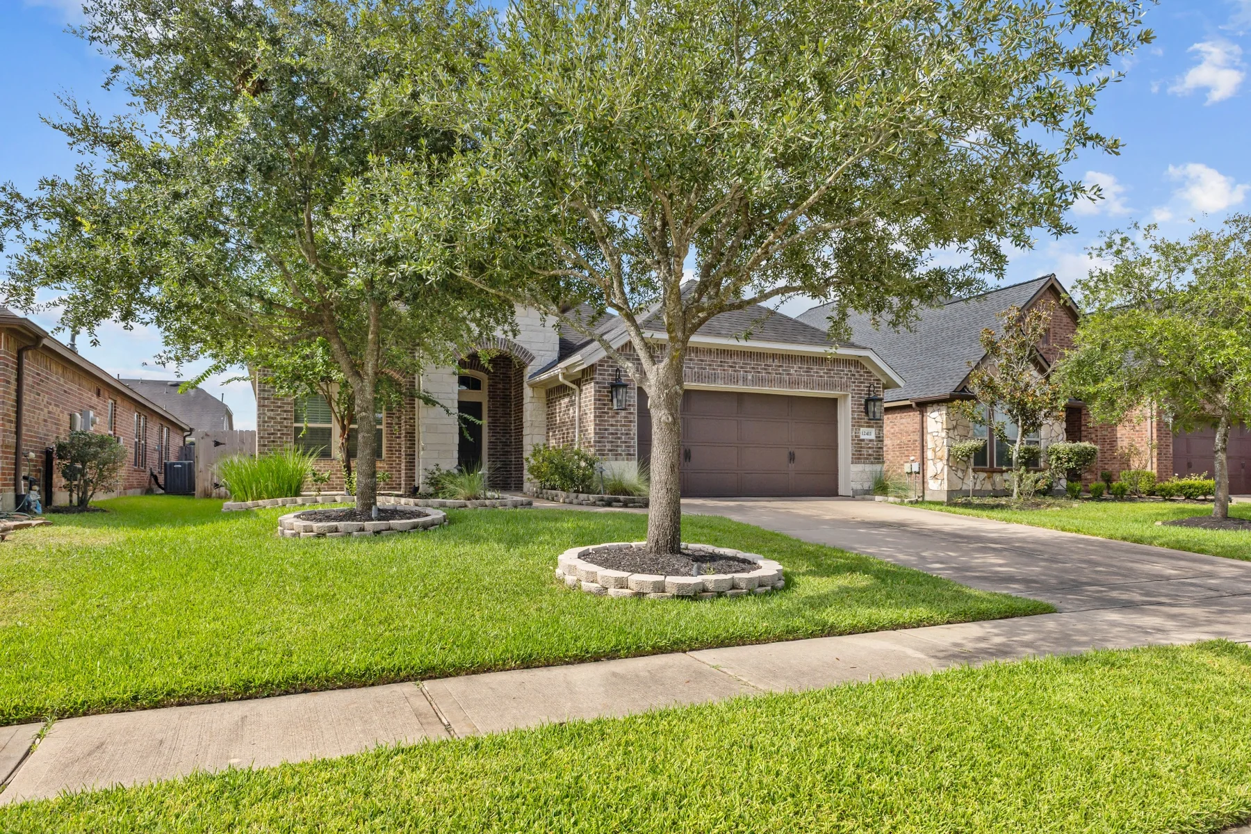 Front exterior of brick and stone suburban home
