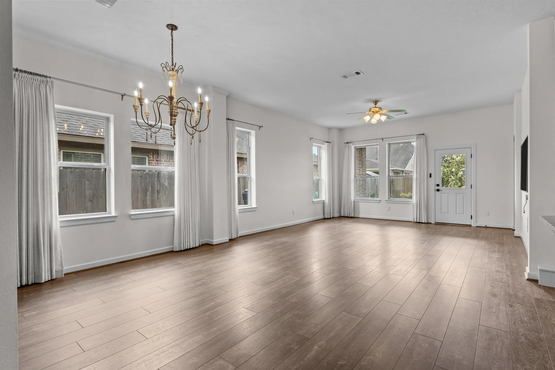 Wide open-concept family and dining area with wood flooring