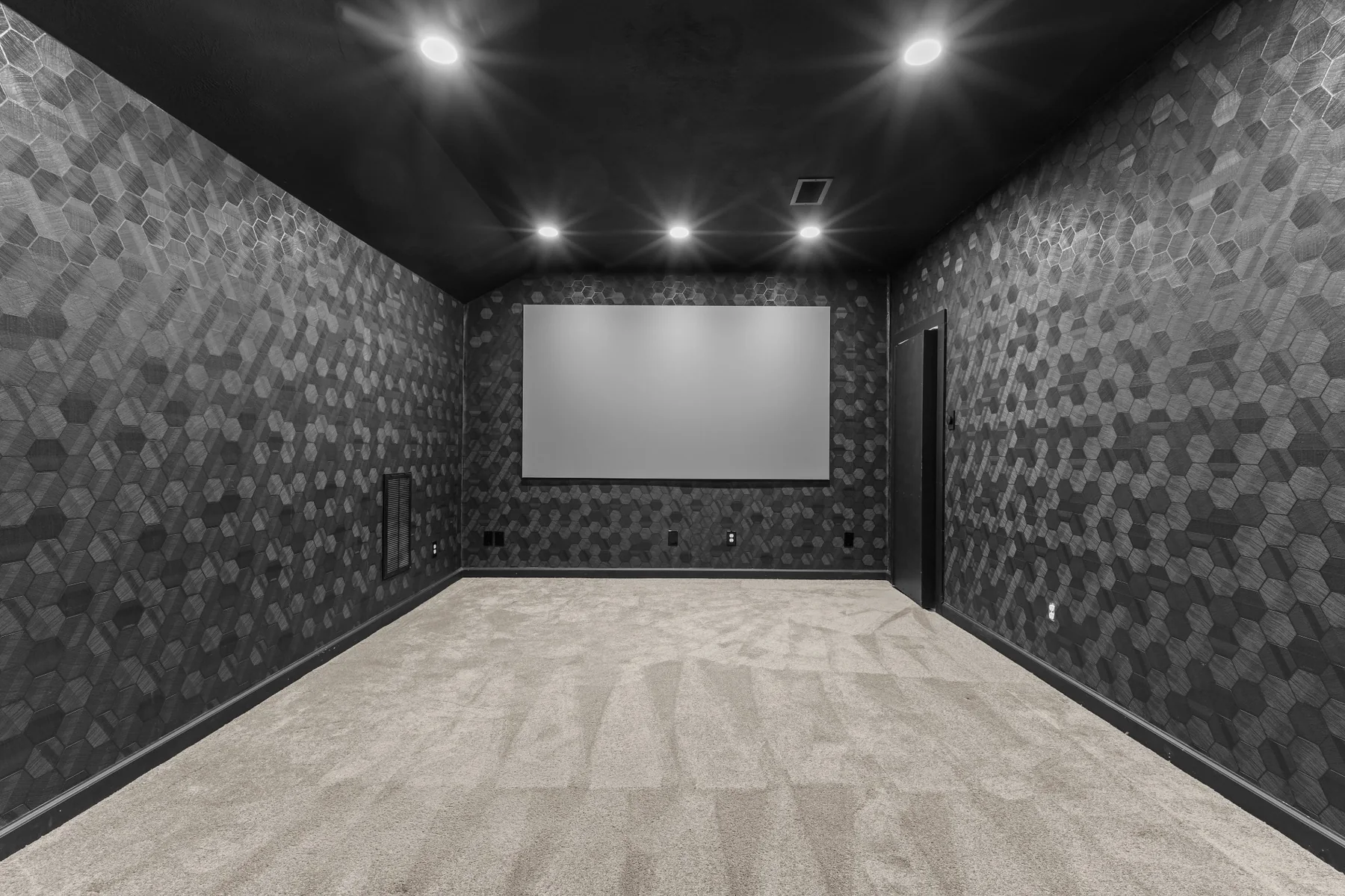 Home theater with projection screen and recessed lighting