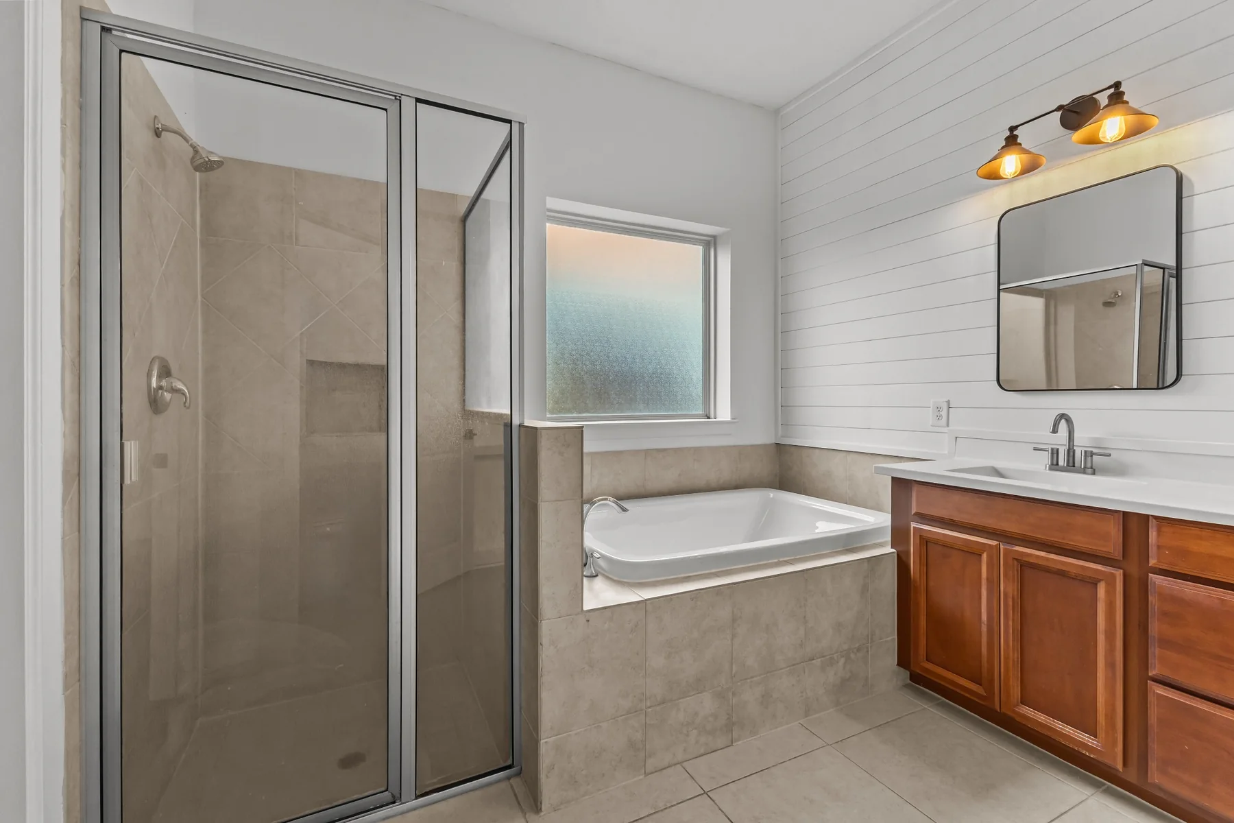 Primary bathroom with glass shower and soaking tub