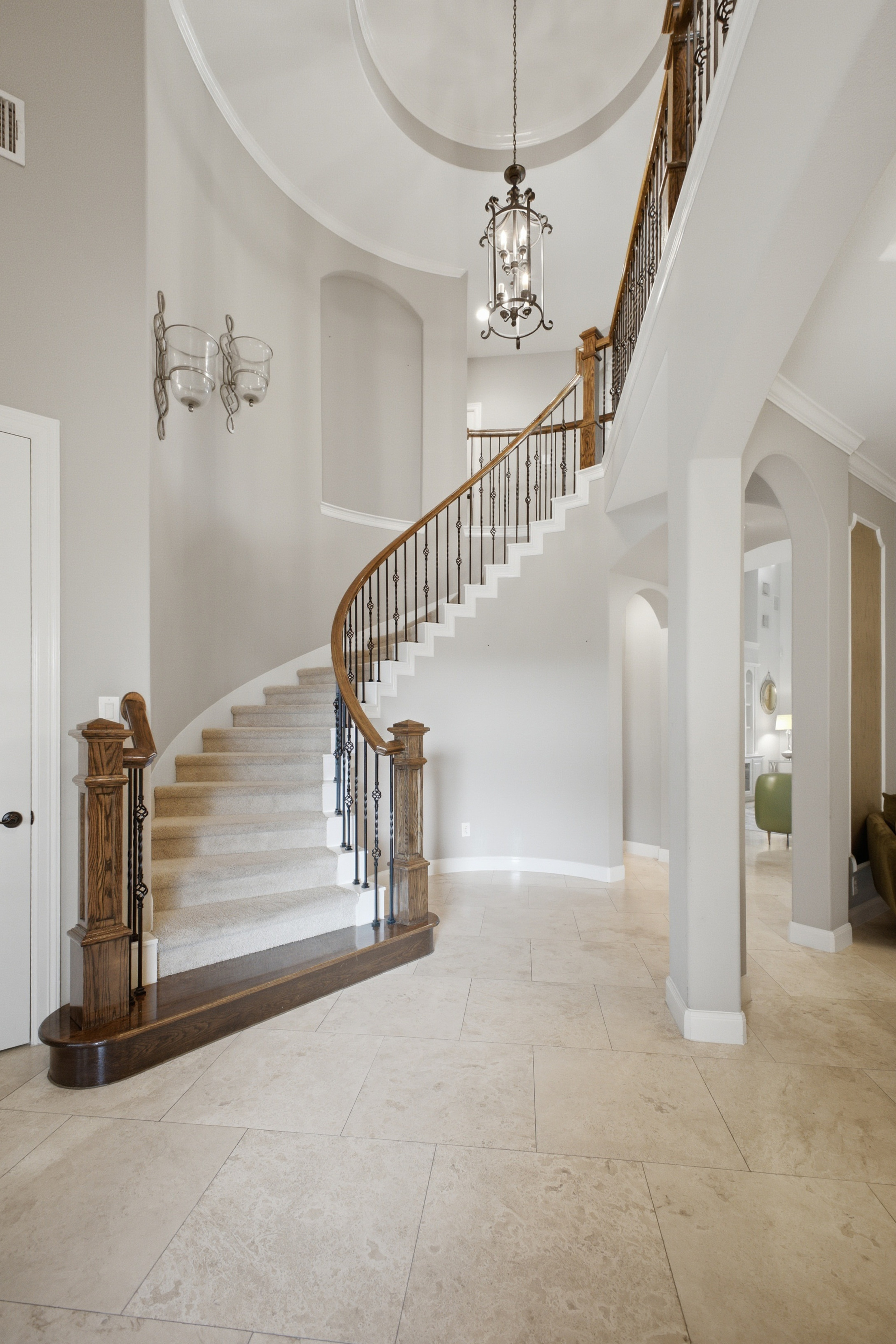 Curved staircase and two-story entry foyer