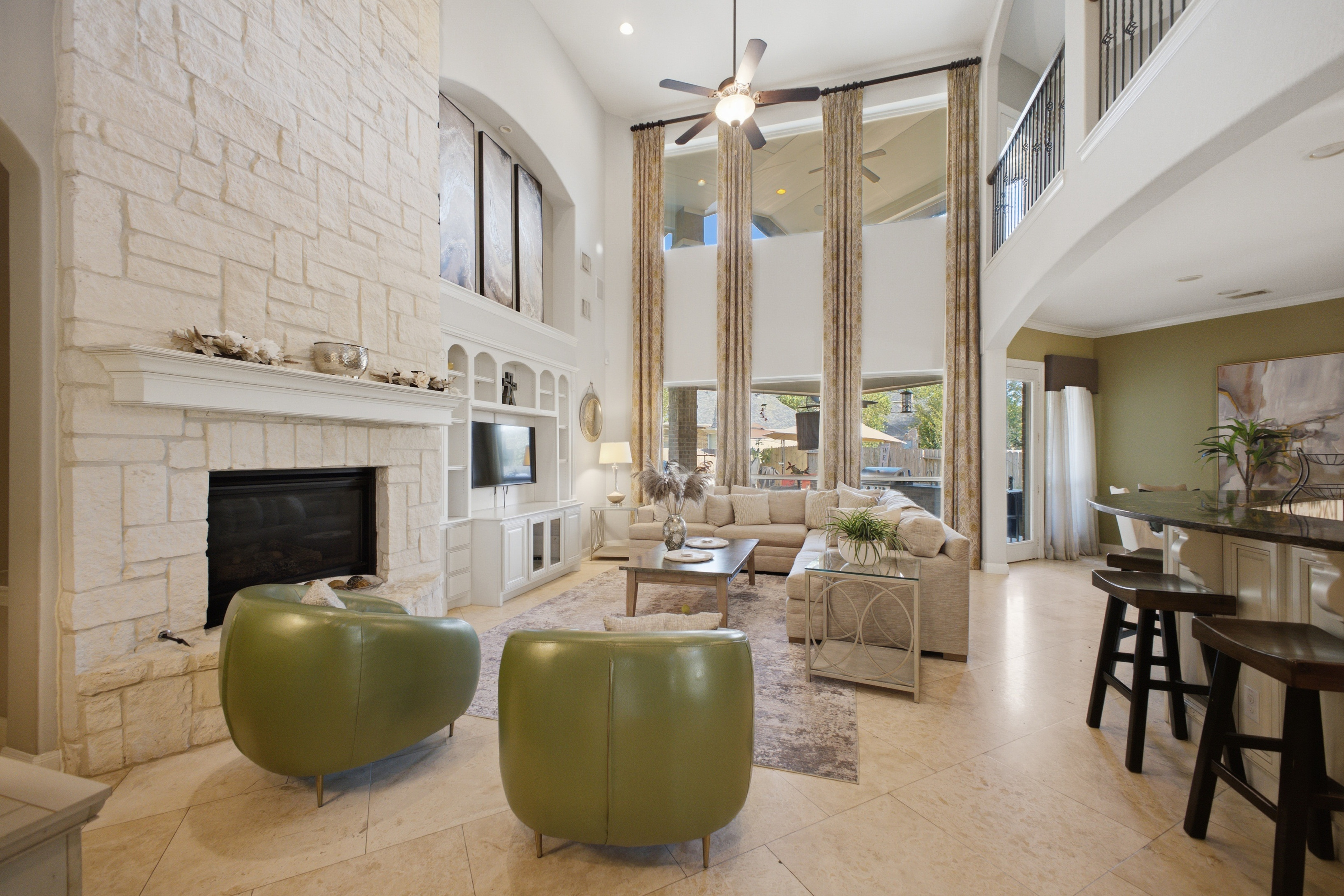 Tall ceiling open modern living room with floor to celing white brick fireplace