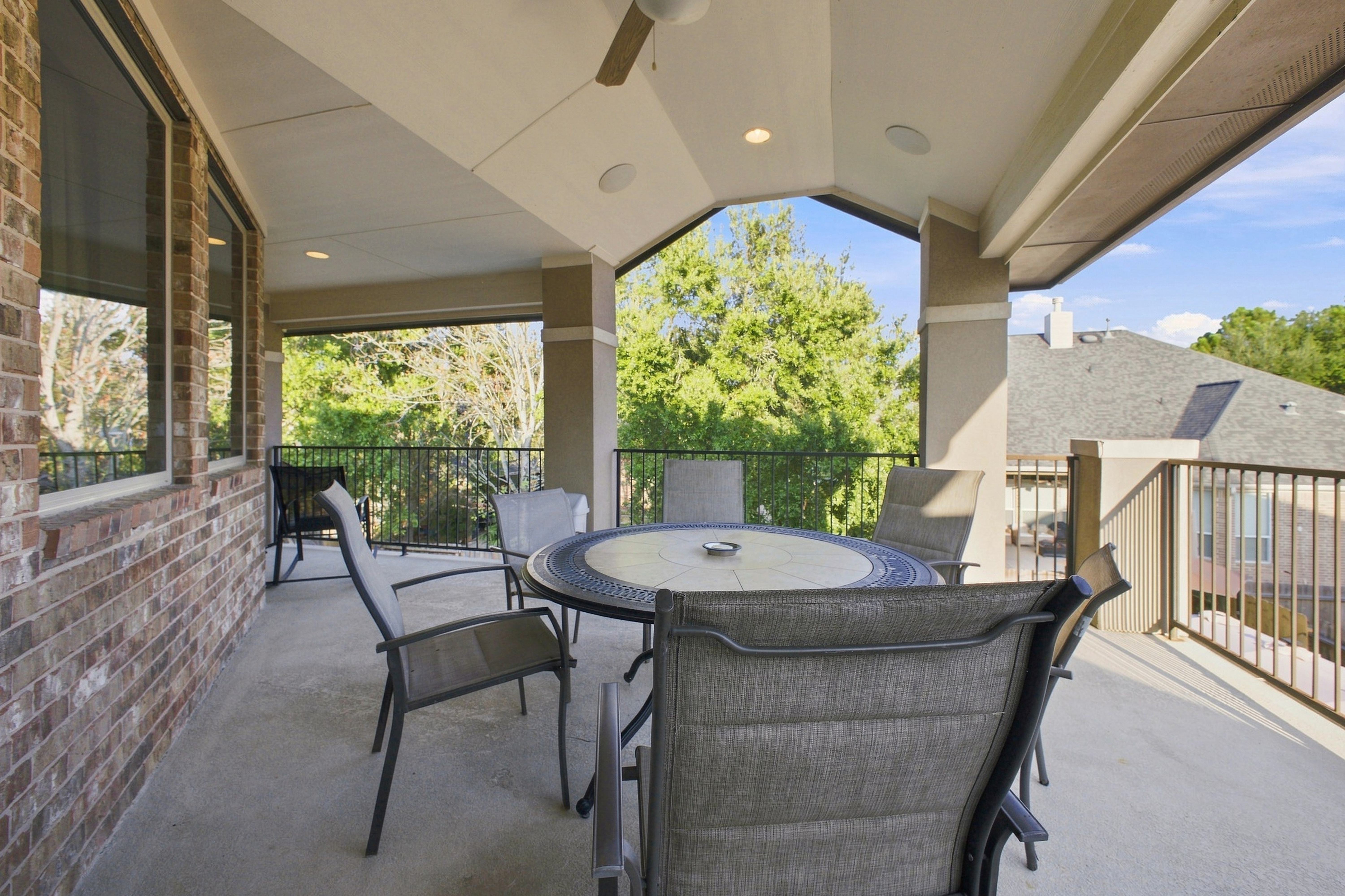 Covered second-story balcony overlooking the backyard