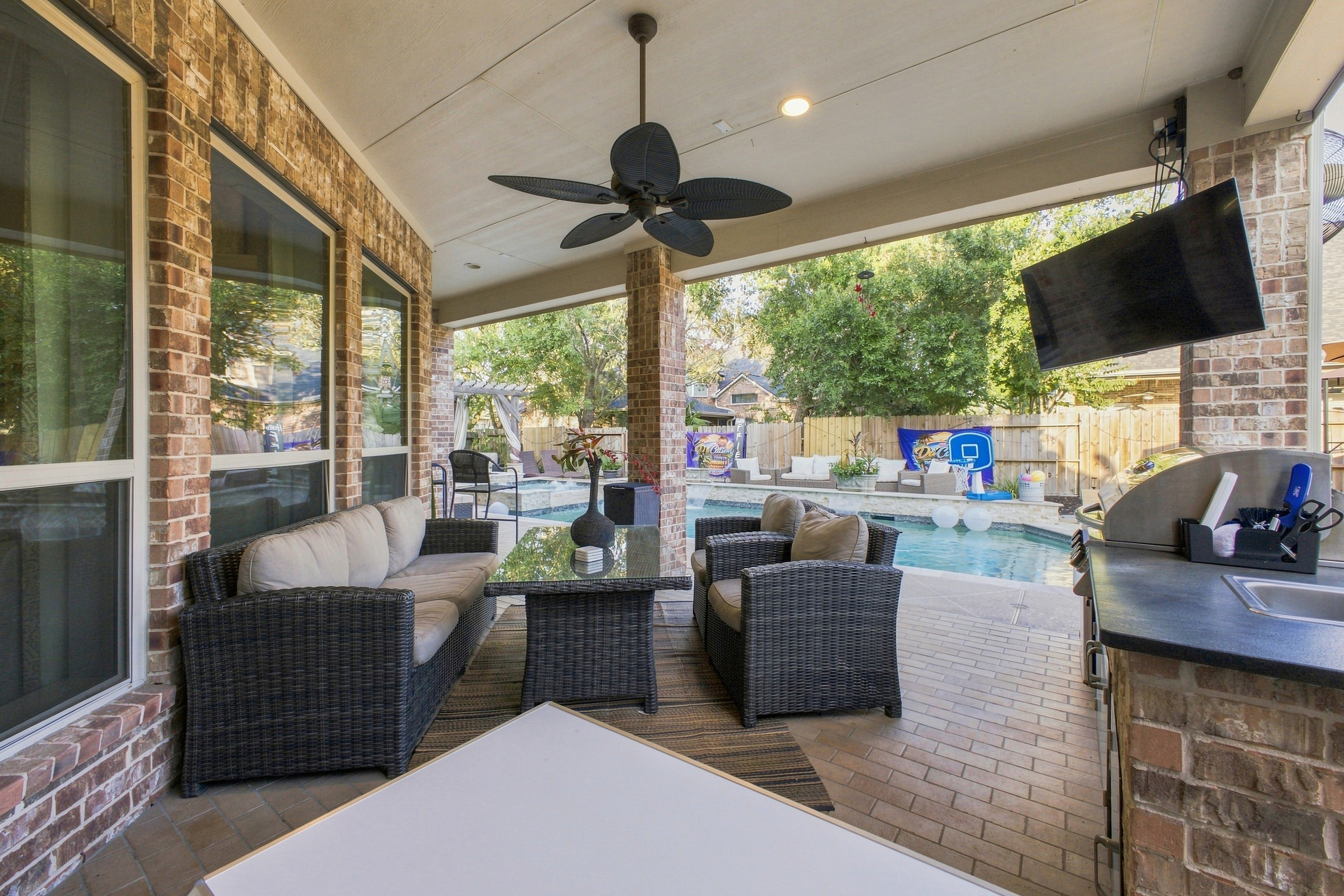 Covered outdoor living area overlooking the swimming pool