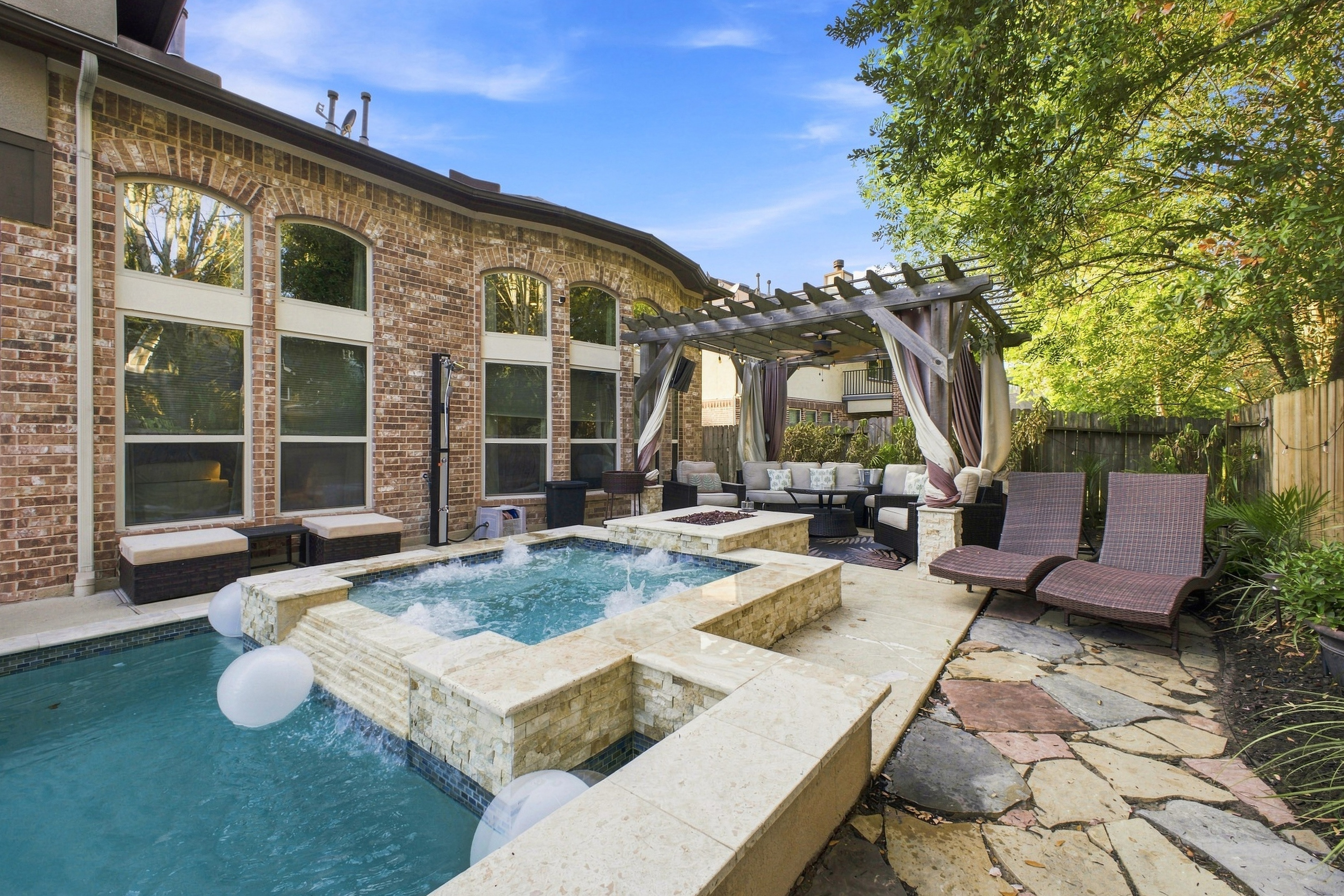 Pool and raised spa with pergola seating area