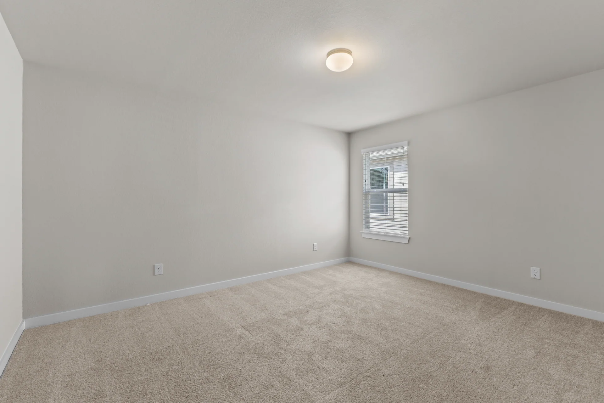 Secondary bedroom with neutral finishes
